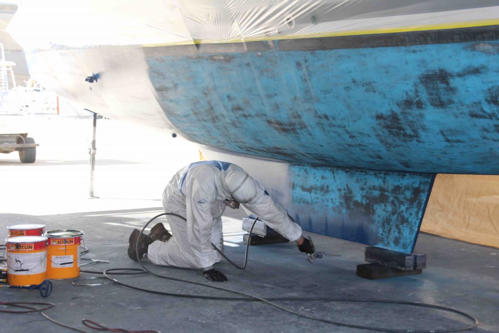 Affordable Antifoul giving the hulls a coat of paint.